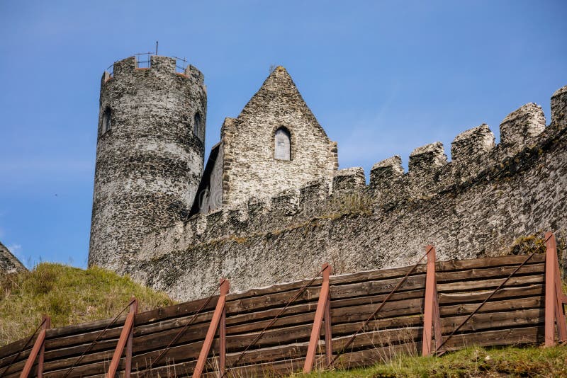 Medieval gothic castle Bezdez, grey stone ruin on hill at sunny day, ancient fortress walls, fairytale stronghold, high round