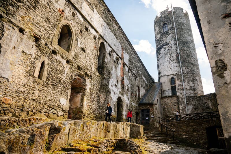 Medieval gothic castle Bezdez, grey stone ruin on hill at sunny day, ancient fortress walls, fairytale stronghold, round tower