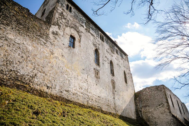 Medieval gothic castle Bezdez, grey stone ruin on hill at sunny day, ancient fortress walls, fairytale stronghold, scalloped walls