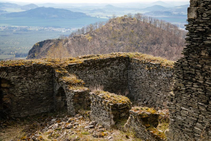 Medieval gothic castle Bezdez, grey stone ruin on hill at sunny day, ancient fortress walls, fairytale stronghold, scalloped walls