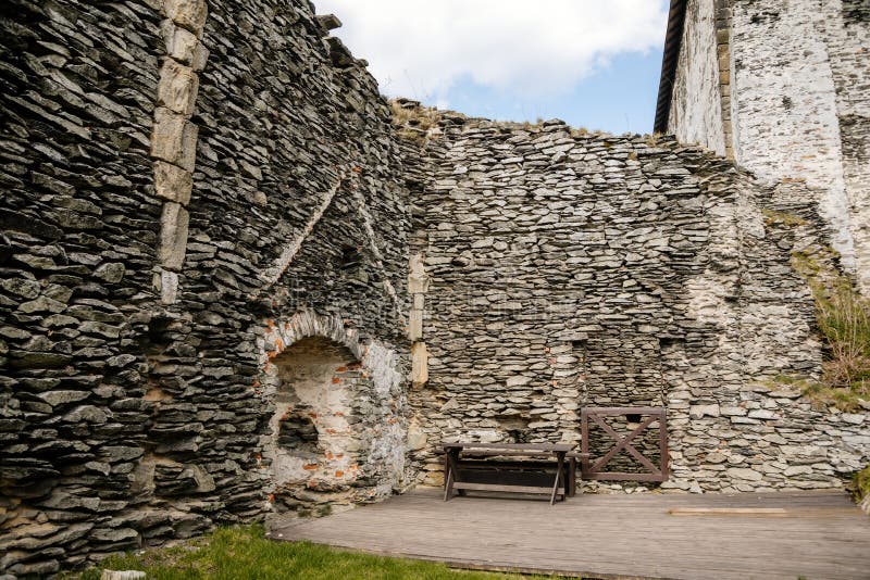 Medieval gothic castle Bezdez, grey stone ruin on hill at sunny day, ancient fortress walls, fairytale stronghold, scalloped walls