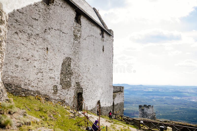 Medieval gothic castle Bezdez, grey stone ruin on hill at sunny day, ancient fortress walls, fairytale stronghold, scalloped walls