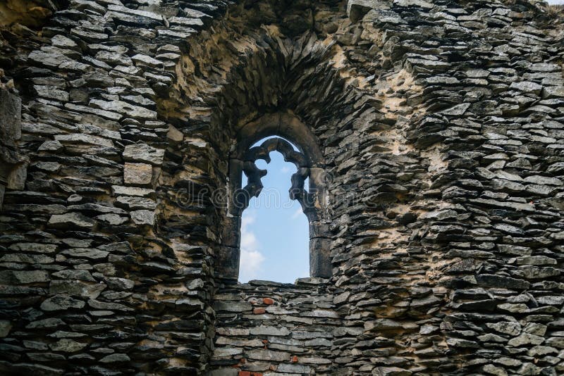 Medieval gothic castle Bezdez, royal palace, grey stone ruin on hill at sunny day, ancient fortress, fairytale stronghold, arched