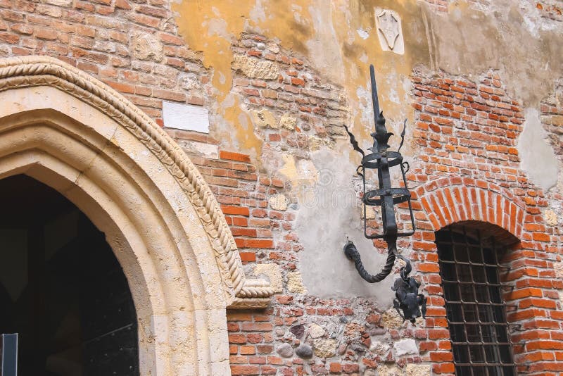 Medieval luminaire on old brick wall of a house