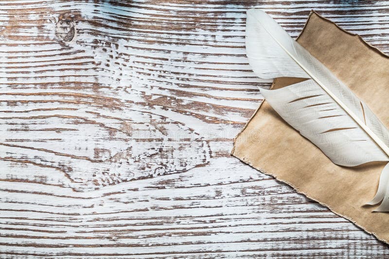 Medieval parchment plume on vintage wooden board stock photo