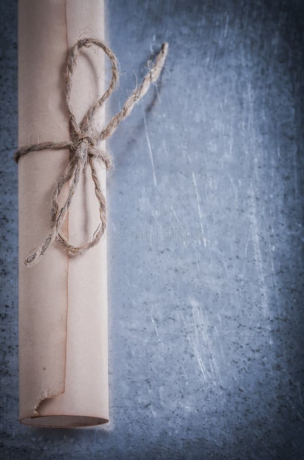 Medieval roll of paper on scratched metallic royalty free stock image