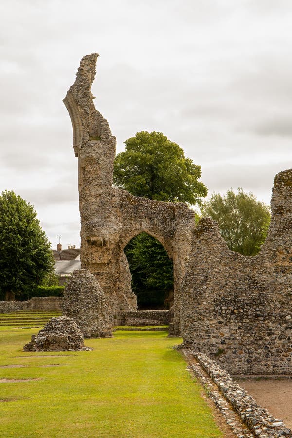 Medieval ruins of clunaic Thetford Priory with largest arch still standing.