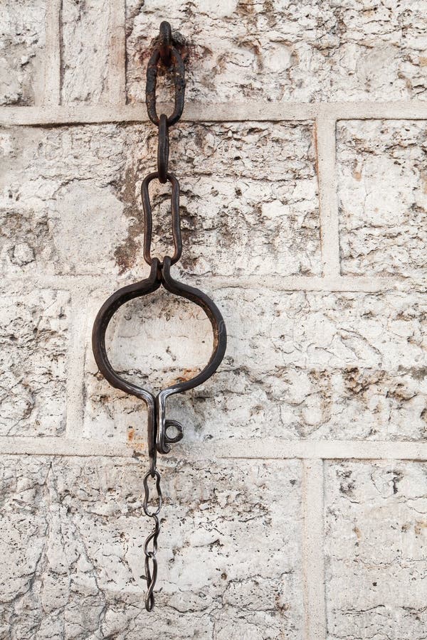 Medieval shackles mounted in old wall