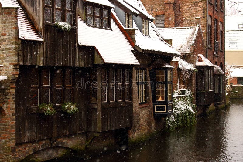 Medieval wooden and brick buildings at canal street in Bruges, Belgium. Winter landscape of old historical town in Europe.