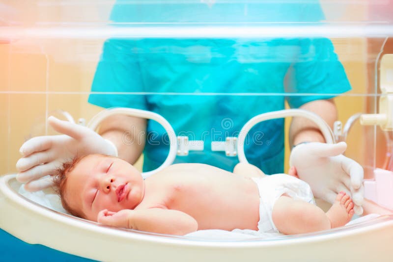 Medisch personeel die pasgeboren baby in zuigelingsincubator behandelen royalty-vrije stock afbeeldingen Medisch personeel die pasgeboren baby in zuigelingsincubator behandelen royalty-vrije stock afbeeldingen