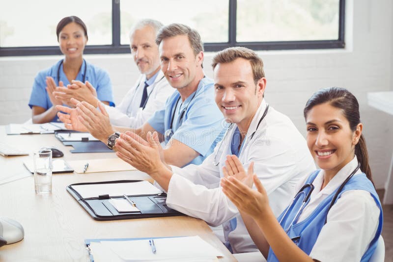 Portrait of medical team applauding in conference room. Portrait of medical team applauding in conference room