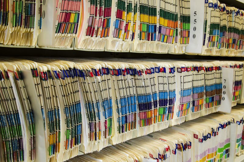 Shelves filled with colorfully labeled medical files. Shelves filled with colorfully labeled medical files