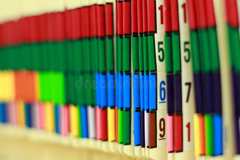 Colorful medical records line the shelf in this doctor's office. Colorful medical records line the shelf in this doctor's office.