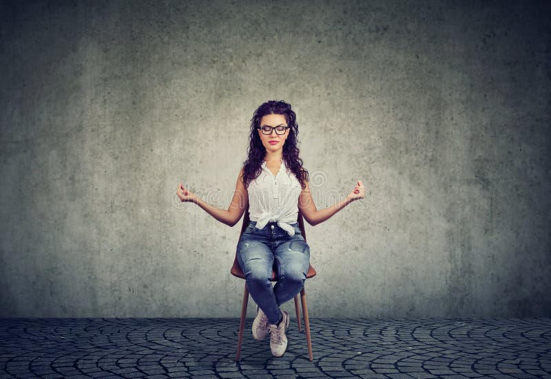 Meditating woman on chair with eyes closed stock image Meditating woman on chair with eyes closed stock image
