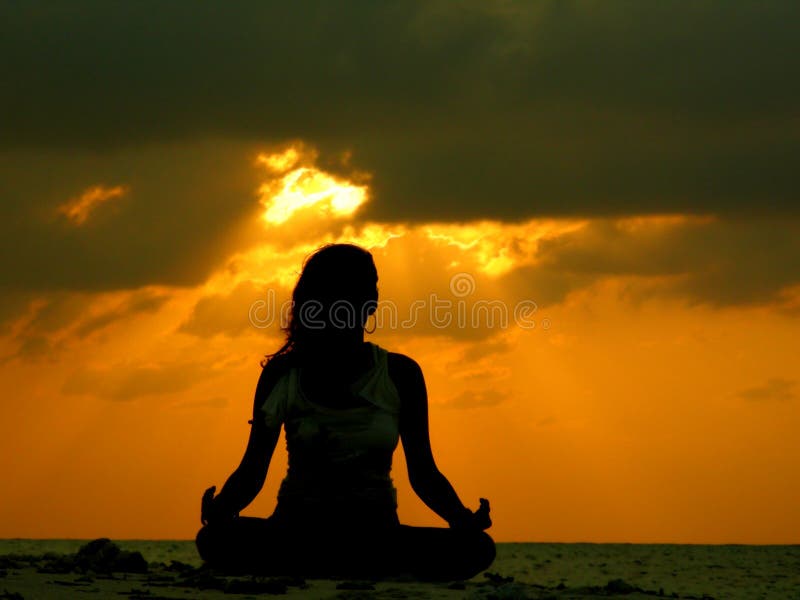 A silhouette of a woman in meditation