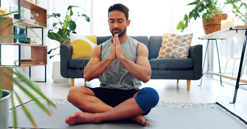 Meditation, yoga or zen asian man in relax, peace and mental health training, workout or exercise in house living room