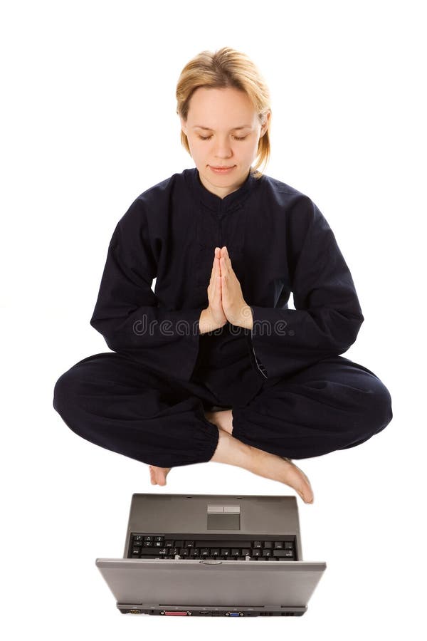 Women in kimono meditation in pose of lotus with laptop on white background. Women in kimono meditation in pose of lotus with laptop on white background