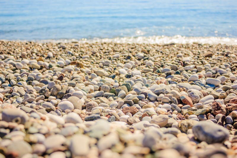 Mediterranean landscape in Antalya, Turkey. Blue sea, waves and pebble sandy beach