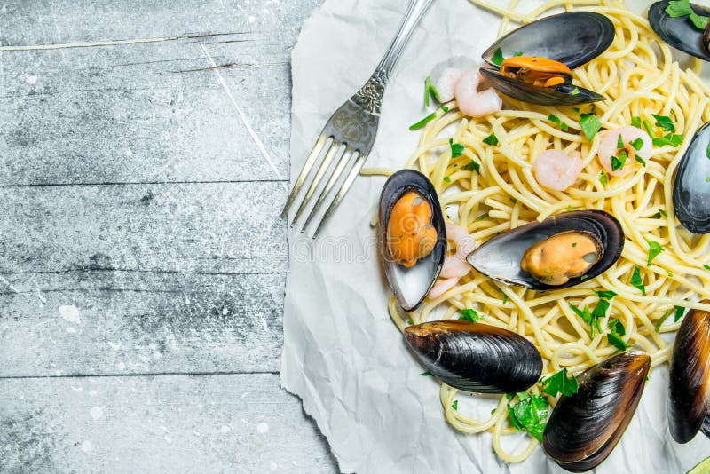 Mediterranean pasta. Spaghetti seafood with clams on paper