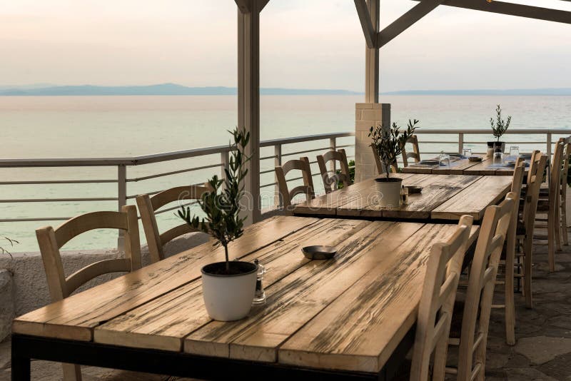 Mediterranean Restaurant Wooden Table With Olive Tree And Sea View