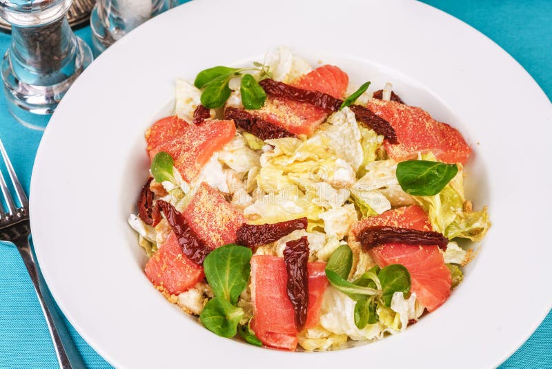 Mediterranean salad. Cabbage, tomatoes, smoked seeds, olives, olives, basil and rosemary, seasoned with olive oil and balsamic sau royalty free stock image