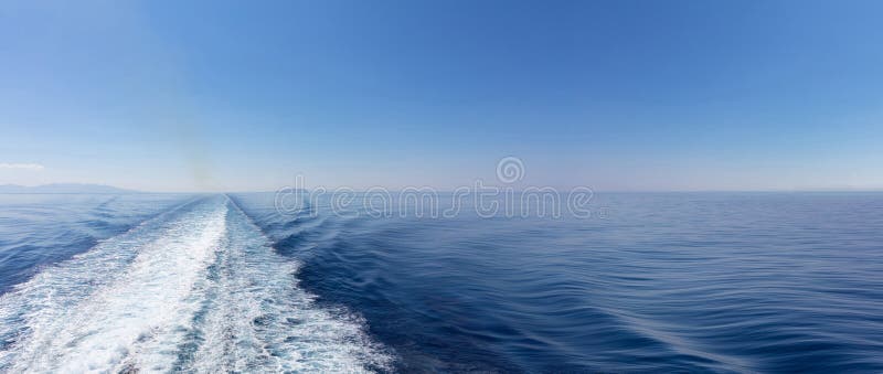 Mediterranean sea. Boat white wake, on blue sea and sky background, view from the ship. Copy space, banner