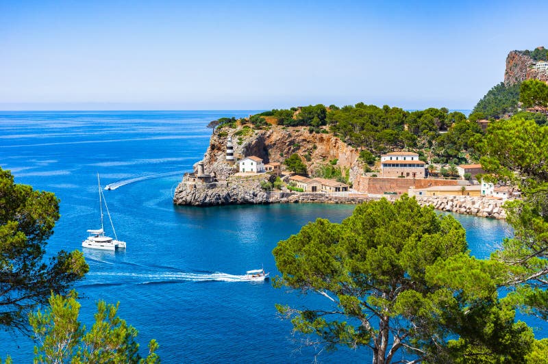 Idyllic view of Port de Soller bay with lighthouse and boats, Mediterranean Sea, Spain, Balearic Islands. Idyllic view of Port de Soller bay with lighthouse and boats, Mediterranean Sea, Spain, Balearic Islands.