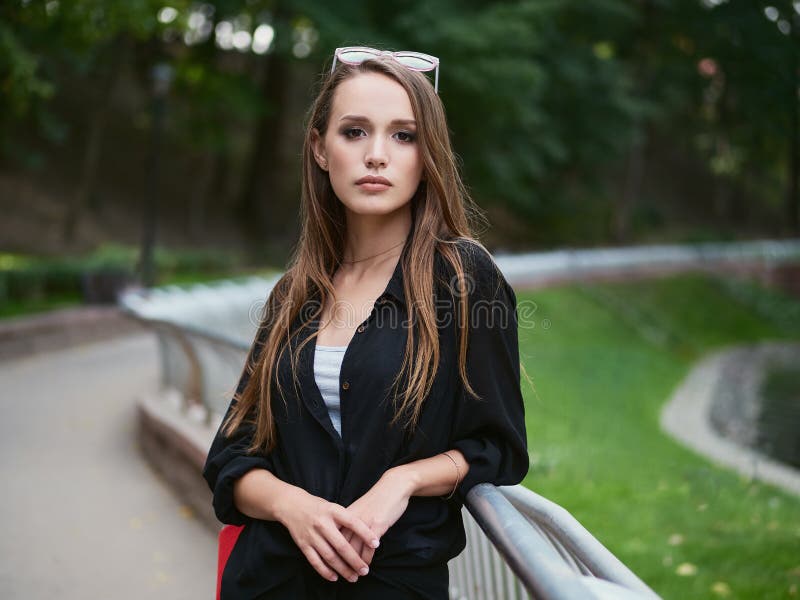 Medium Shot of Fashionable Elegant Young Woman with Long Hair Looking ...