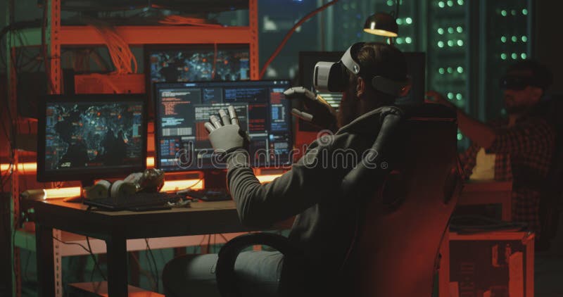 Hackers using VR headset and gloves stock photo
