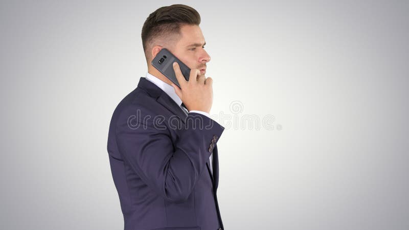 Businessman talking on the phone on gradient background. royalty free stock images