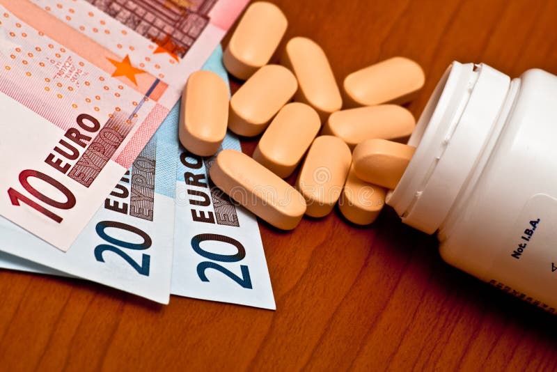Medizinbehälter und -geld lizenzfreie stockfotografie Medizinbehälter und -geld lizenzfreie stockfotografie