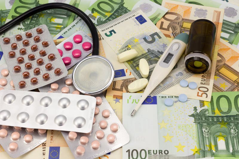 Medical pills,stethoscope and thermometer in euro money background as a symbol of health care costs sample. Medical pills,stethoscope and thermometer in euro money background as a symbol of health care costs sample