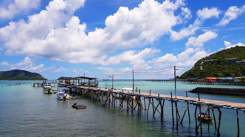 Meerblickansicht. viel Schnellboot geparkt am Hafen mit Holzbrücke unter dem Meer und blauen dem Himmel- und weißenwolkenhintergru. viel Schnellboot geparkt am Hafen mit Holzbrücke unter dem Meer, blauer Himmel- und weißerwolkenhintergrund in samaesarn Strand Chon Buri Thailand. schöne Korallen des klaren Wasser. Landschaft.