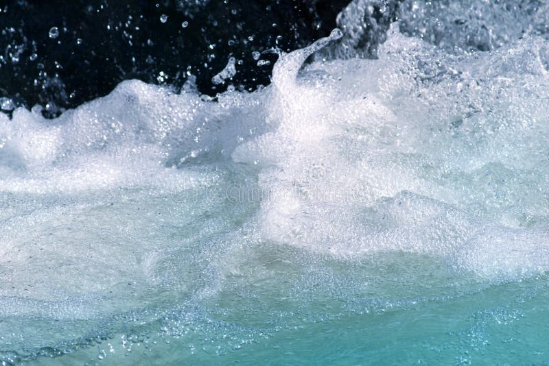 Close-up of rushing, foaming water in a stream. Close-up of rushing, foaming water in a stream