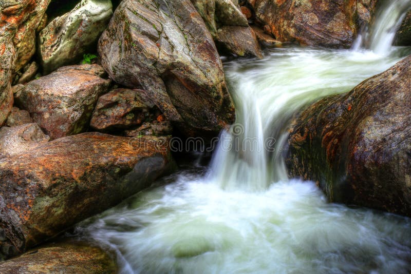 Rushing Waters Of The Smoky Mountains IIWestern North Carolina is home to thousands of waterfalls and tens of thousands of cascades heading down stream no matter what size. These boulders are washed clean with rising waters from streams and river. Small cascade was created from Sunburst Falls. Rushing Waters Of The Smoky Mountains IIWestern North Carolina is home to thousands of waterfalls and tens of thousands of cascades heading down stream no matter what size. These boulders are washed clean with rising waters from streams and river. Small cascade was created from Sunburst Falls.