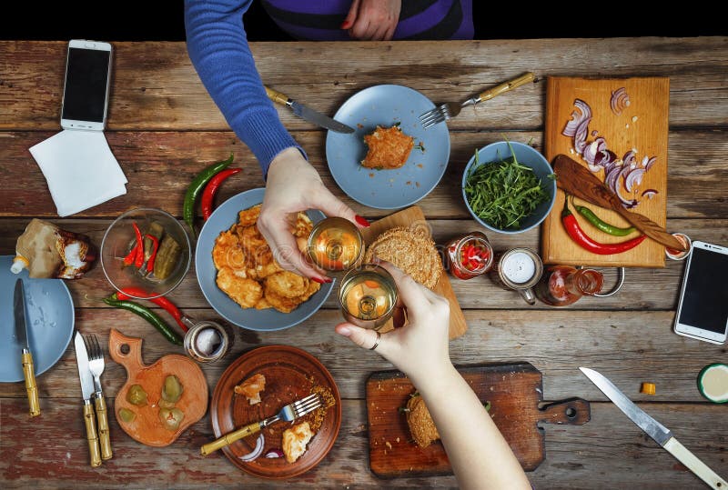 Meeting friends at the dinner table with American snacks and wine. Up of glasses of wine toast. stock photos Meeting friends at the dinner table with American snacks and wine. Up of glasses of wine toast. stock photos