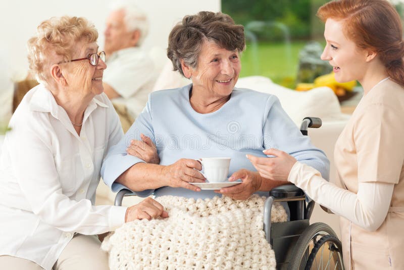 Meeting of happy and smiling senior women and caregiver in the s royalty free stock images Meeting of happy and smiling senior women and caregiver in the s royalty free stock images