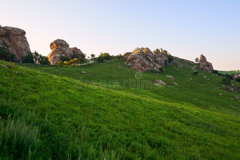 The megalith granite on the alpine meadow sunset