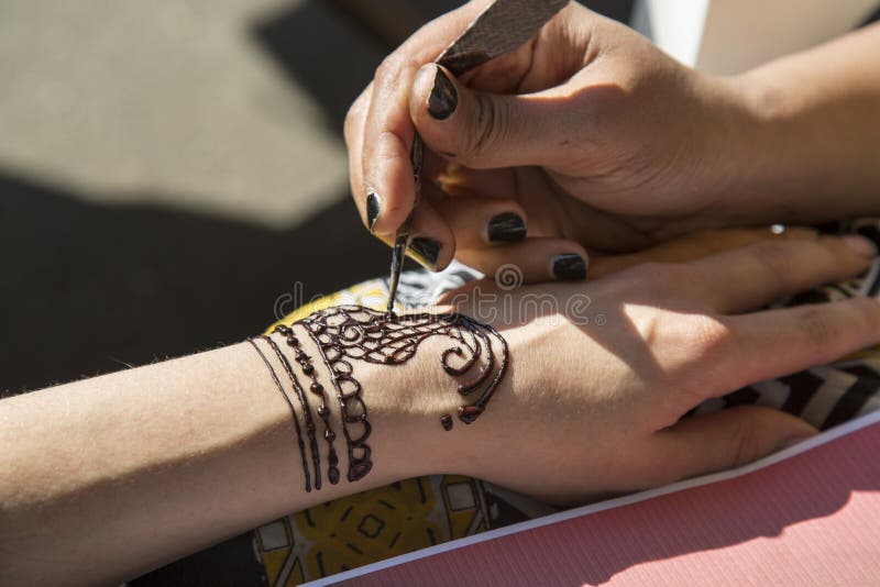 Mehendi Indian Painting on his hands, applied drawing paste. Indian Eastern culture. Mehendi Indian Painting on his hands, applied drawing paste. Indian Eastern culture.