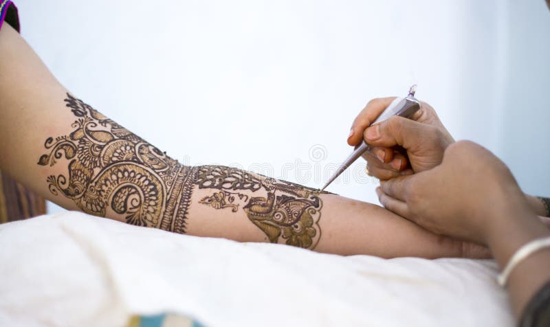 An Indian bride getting ready with Mehendi or Henna an Indian style tattoo. An Indian bride getting ready with Mehendi or Henna an Indian style tattoo.