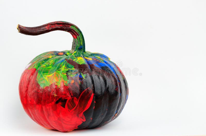 An isolated shot of a multicolored painted Halloween pumpkin. An isolated shot of a multicolored painted Halloween pumpkin.