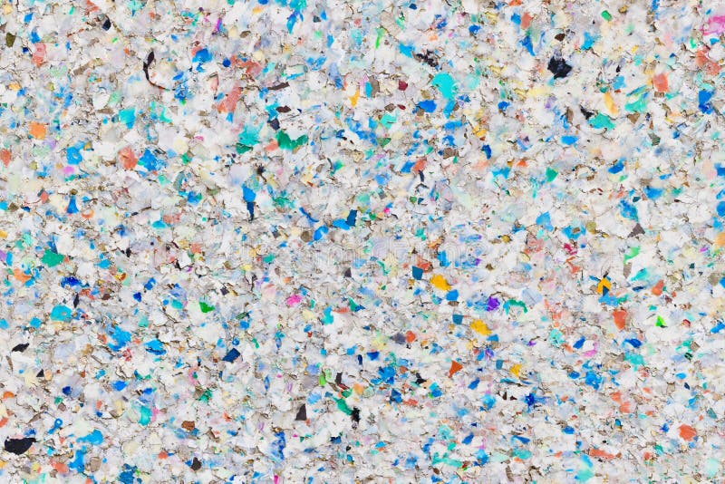 Rough texture of a decomposing weathered board made of r multicolored ecycled plastic pellets. Rough texture of a decomposing weathered board made of r multicolored ecycled plastic pellets