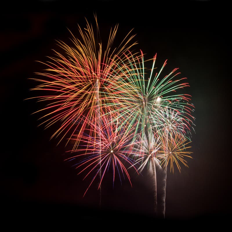 Multicolored fireworks against a black night sky square. Multicolored fireworks against a black night sky square