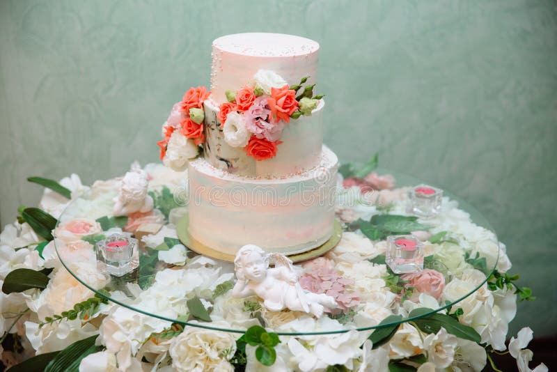 Mehrstufige Hochzeitstorte verziert mit Blumenständen auf einer Tabelle Konzept des Essens, der Bonbons und der Nachtische an ein stockfotografie Mehrstufige Hochzeitstorte verziert mit Blumenständen auf einer Tabelle Konzept des Essens, der Bonbons und der Nachtische an ein stockfotografie