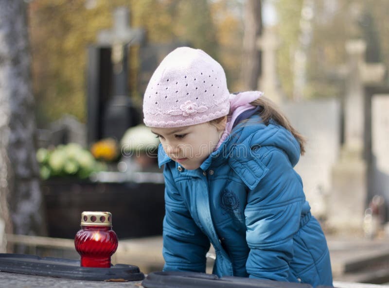 Girl mourning at the grave on cemetery. Girl mourning at the grave on cemetery