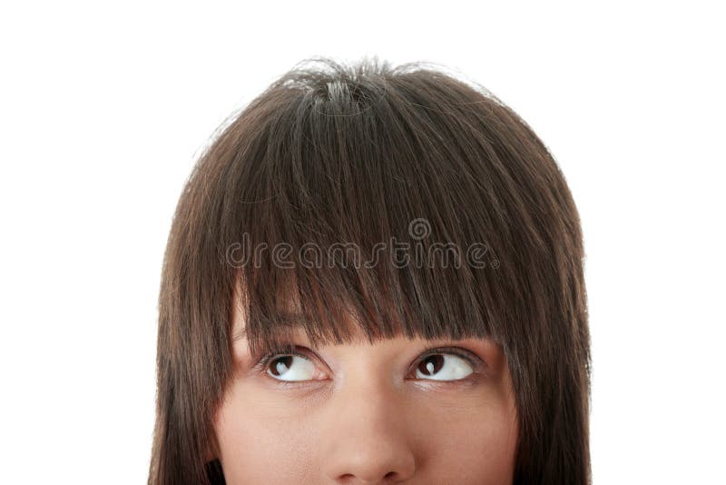 Cropped image of a young girl with her eyes looking away left isolated on white background. Cropped image of a young girl with her eyes looking away left isolated on white background