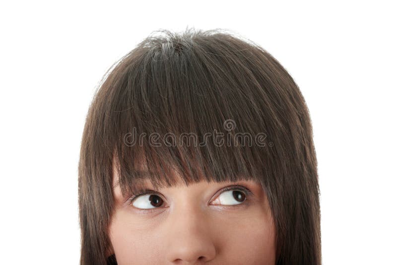 Cropped image of a young girl with her eyes looking away right isolated on white background. Cropped image of a young girl with her eyes looking away right isolated on white background