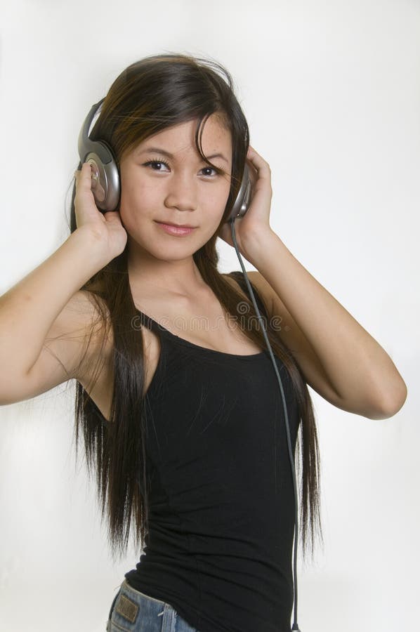 young girl listening to music on headphones. young girl listening to music on headphones