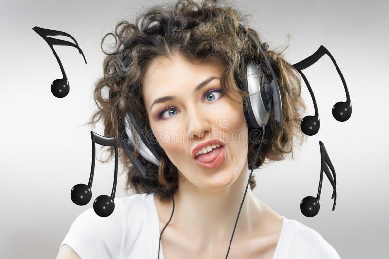 Girl with headphones on the grey background. Girl with headphones on the grey background