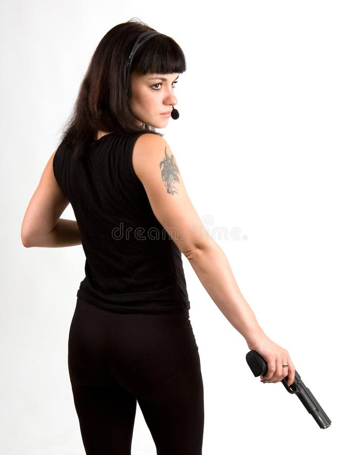 Sexi girl in black dress with gun and headphones. Sexi girl in black dress with gun and headphones.